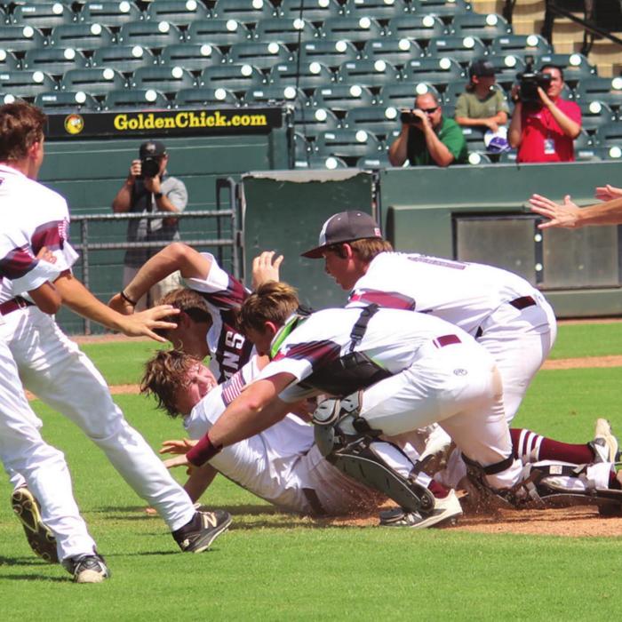 The Lions pile onto one another near the pitcher’s mound after the final out of Thursday’s state title game. Photos by Jeff Wick