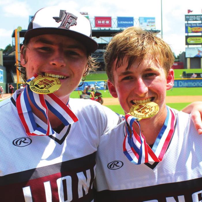 Parker Vitek, left, and Logan Fritsch, right, savor their state championship medals.