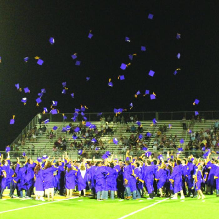 The seniors throw their graduation caps into the sky at the conclusion of Thursday’s ceremony. Photo by Jeff Wick