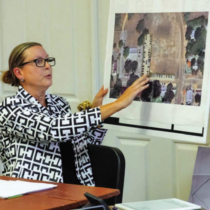 Mayor Judith Vincent holds up a rendering of a parking lot superimposed on a Google Maps image of the Bethlehem Lutheran Church grounds