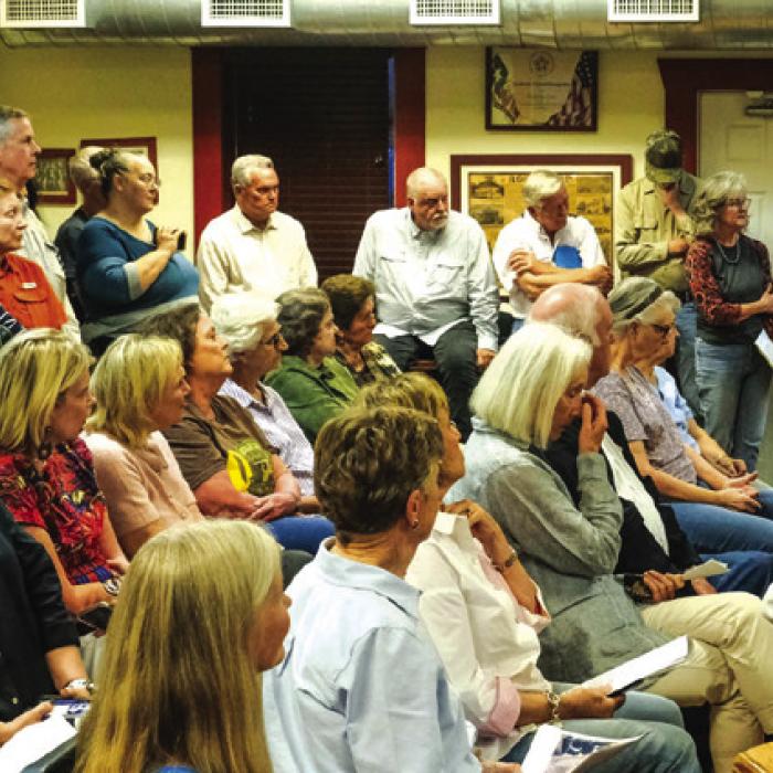 A standing-room only crowd filled the Round Top Town Council meeting last Thursday for a discussion about public parking on “Third Street,” an undeveloped right-of-way that runs through the Bethlehem Lutheran Church grounds. Here, the crowd listens as Julie Robertson (in blue at the far right) urges civility and respect. Photos by Andy Behlen