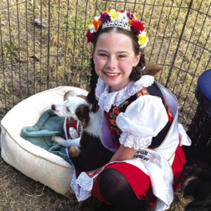 Texas Czech Slovak Little Princess Lillie Karstedt stopped by the Gardenia Janssen Animal Shelter booth to play with some of the dogs up for adoption at the fest.