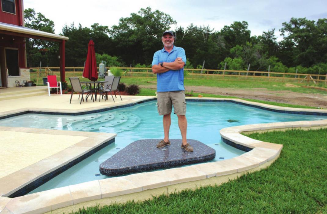 Joe Arnold stands atop the swim-up table that’s positioned in the Big Bend portion of the Texasshaped swimming pool in his backyard. Photo by Jeff Wick