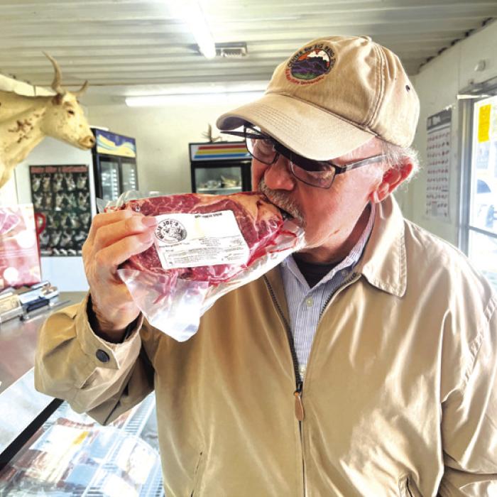 Pancho Howze pretends to take a bite from a steak he bought at Willie Joe’s in High Hill.