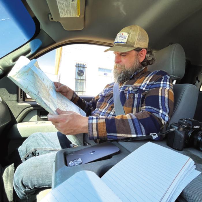 Andy Behlen consults the county map before we depart Muldoon.