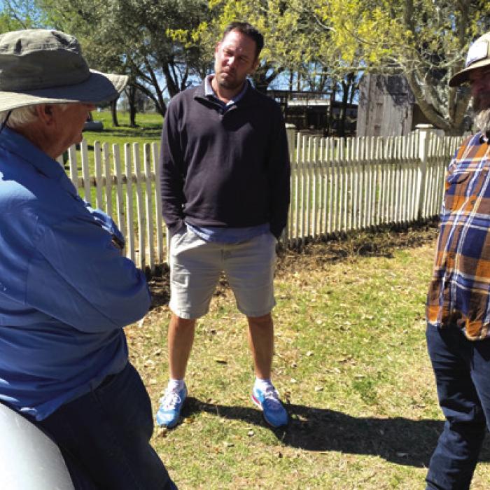 Former Fayette County Judge Ed Janecka leans against his car, left, as he chats with Jeff Wick and Andy Behlen at Janecka’s place in Dubina.