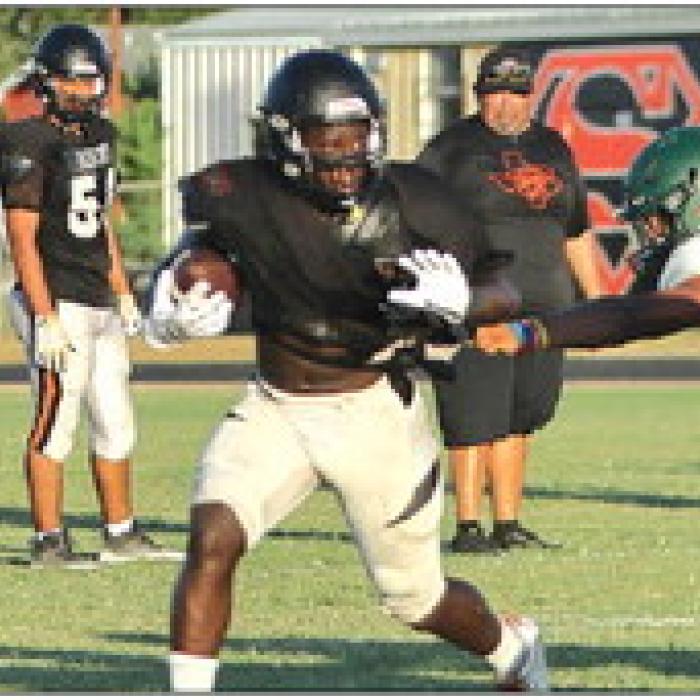 New Schulenburg offensive coordinator Brandon Williams (left) formerly of Flatonia, reacts as Shorthorn running back Rodney Walton runs the ball Thursday. Photo by Darrell D. Gest