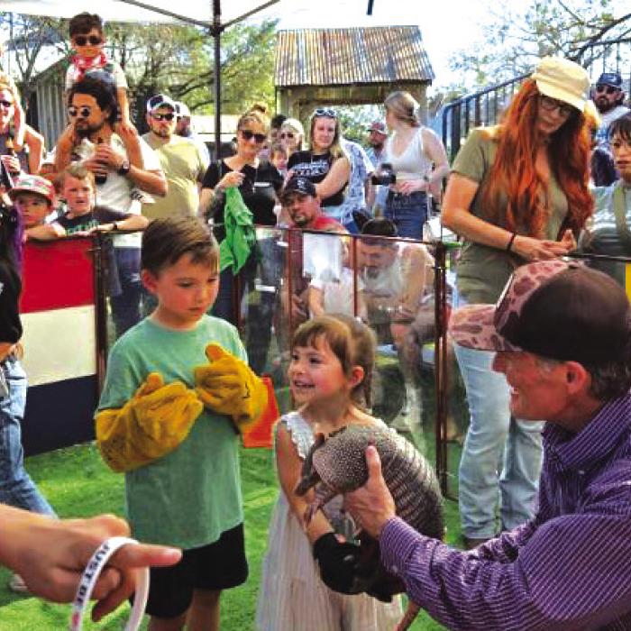 Swiss Alp’s Ralph Fisher took his armadillos to Gruene Hall March 1 for a special Texas Independence Day Weekend event, where a steady stream of attendees enjoyed holding and racing the Armadillos. Photo courtesy of Gary Wessels