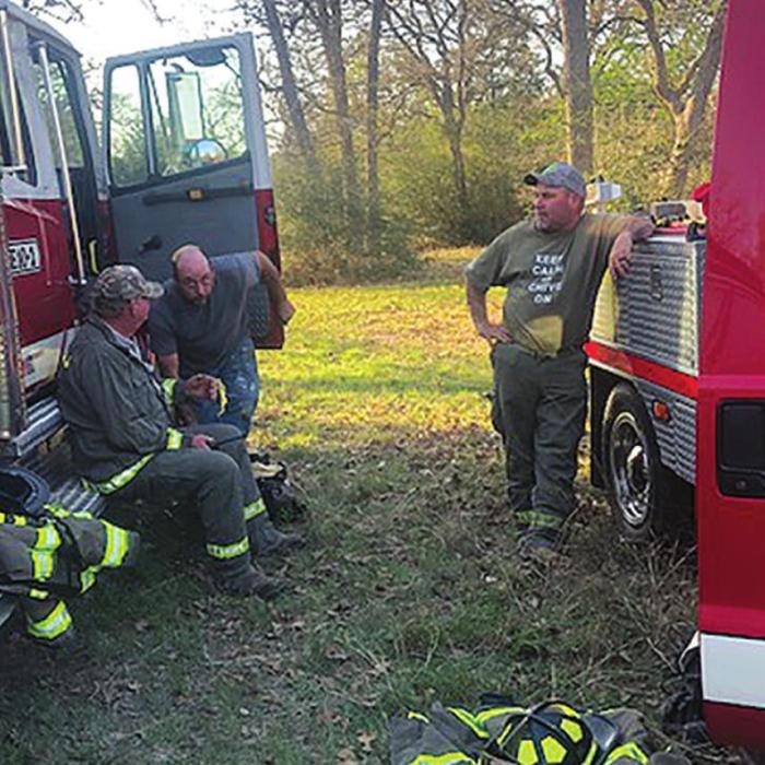 Muldoon firefighters took cover behind their trucks when they thought a property owner was shooting at them during a fire in the Jeddo area last Friday. As it turned out, there were no gunshots. However, the property owner was arrested for criminal mischief and resisting arrest. Photo courtesy of Muldoon VFD