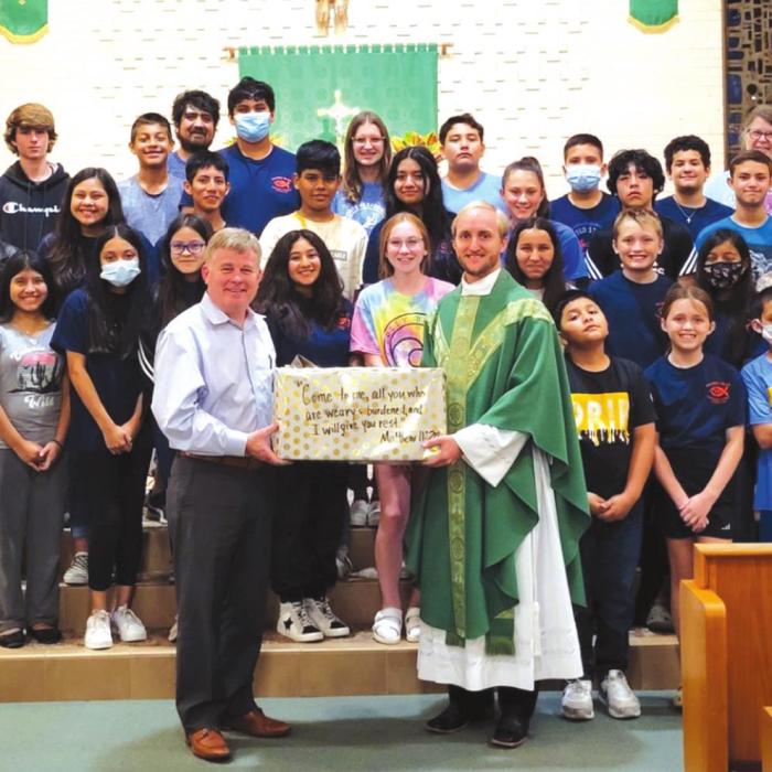 Mark Kimball, president and CEO of SMMC, Father Brian Phillips, pastor of Sacred Heart Catholic Church, Karissa Kleiber, CYM Youth Minister, CYM members and their adult leadership.