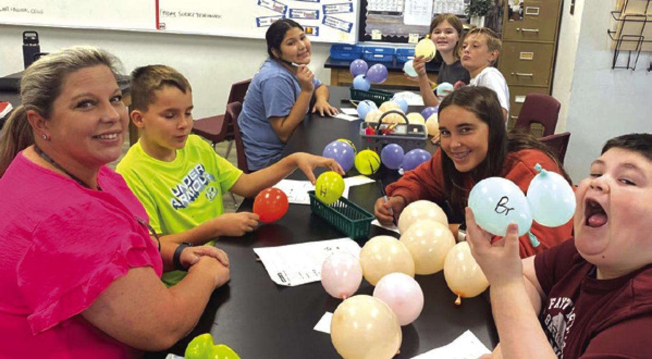 FISD 6th graders with their balloon molecules.