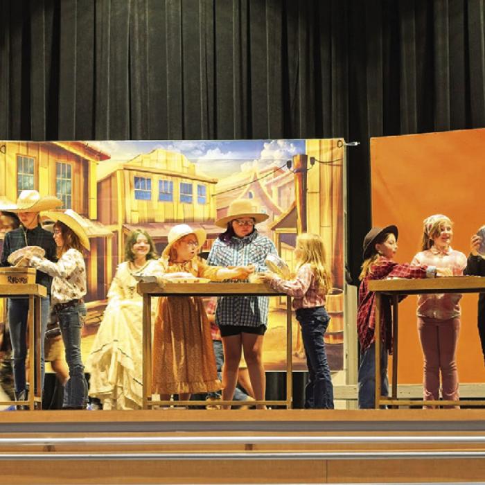 Under the watchful eye of student director Deacon Wick, right, several cast members of “Abandoned Way Out West” rehearse a chaotic pie-making scene last week. Photo by Meadow Taylor-Marklin
