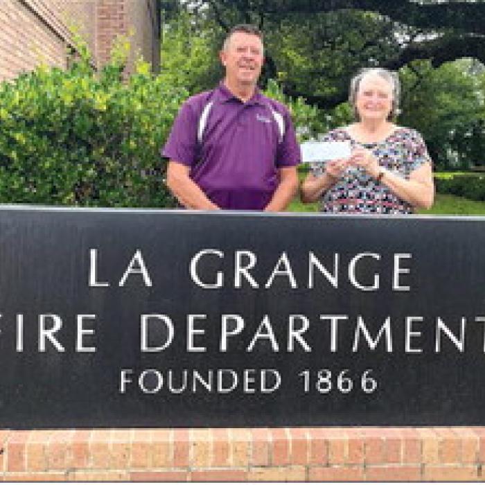 Helping Hands donated $300 from Hermann Sons Life Lodge No. 238 of Plum to the La Grange Volunteer Fire Department. Pictured are Frank Menefee, La Grange Fire Chief, and Linda Poncik.