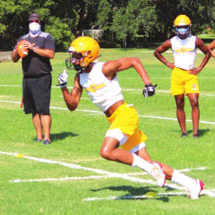 Masked La Grange football assistant coach Eric Amick prepares to throw a pass to a Lep receiver Monday.