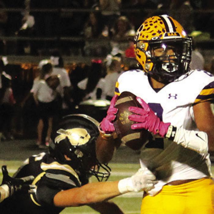 Jaden Williams looks downfield under pressure from Giddings last week.