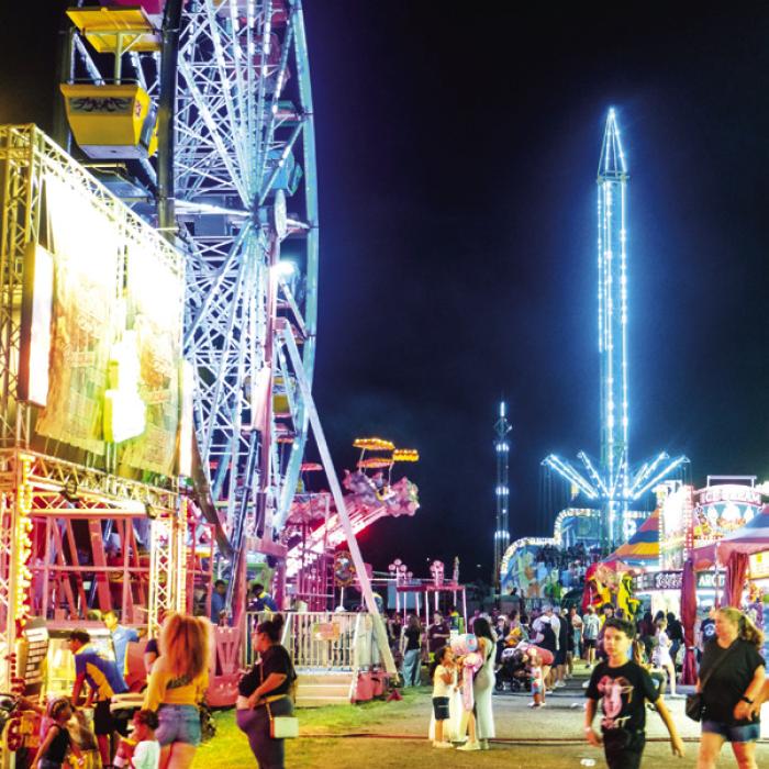 The carnival midway on opening night of the county fair. Photo by Andy Behlen
