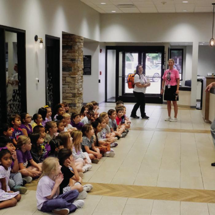 National Bank and Trust President Scott McManus speaks to the kindergarten class about what goes on inside the bank.