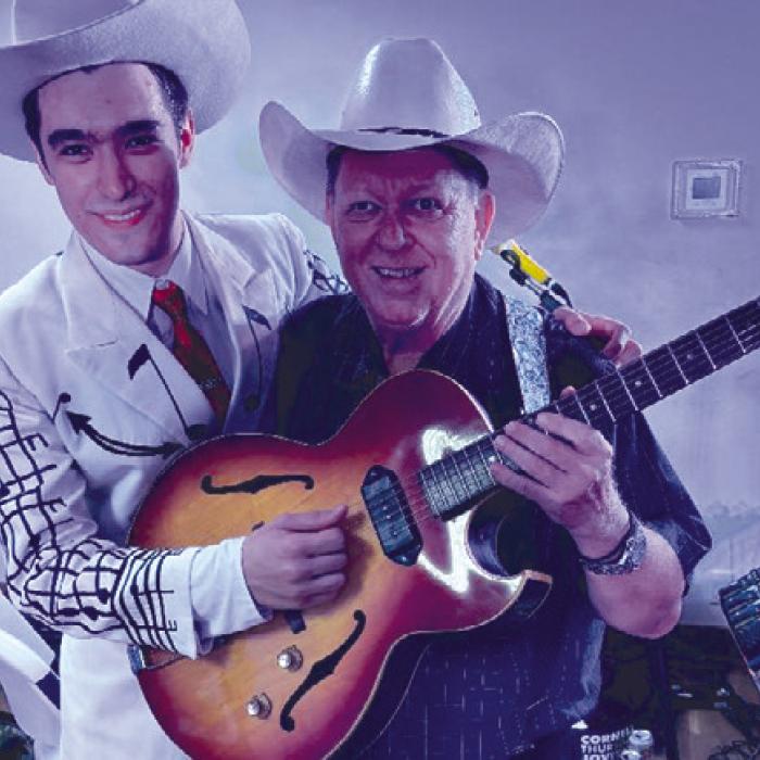 Wyatt Aleman is pictured here with local musician Mark Lehmann following the recent Hank Williams Tribute Show at the Fayette County Country Music Opry. They’re holding a periodcorrect electric guitar provided by the wife of the late Austin swing/country guitar singer “Boomer” Norman. Photo courtesy of John Dujka