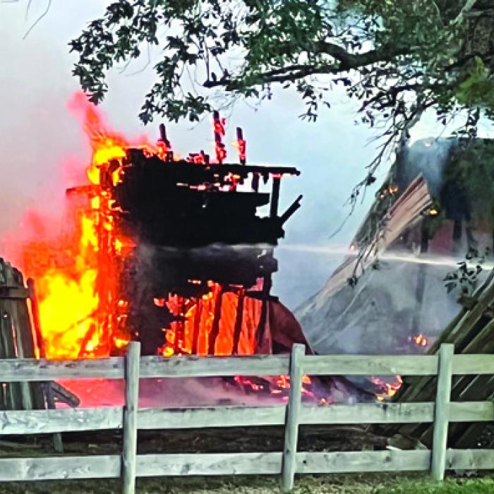 The house was fully engulfed in flames Saturday when firefighters arrived, and the flames were beginning to threaten several nearby homes. The fire had spread to a shed on the property, several trees and a neighbor’s fence.