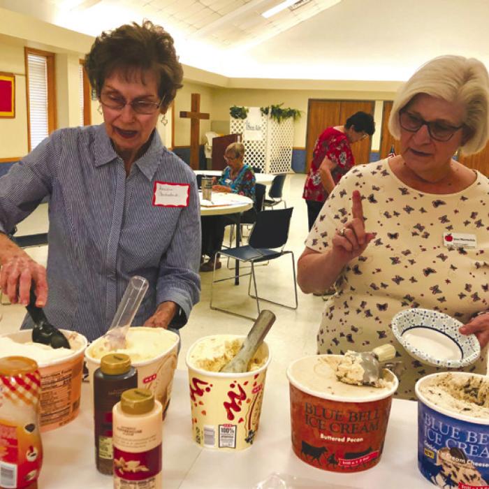 Fayette County Retired Teachers Association members Sandra Aschenbeck and Joan Miertschin enjoy ice cream.
