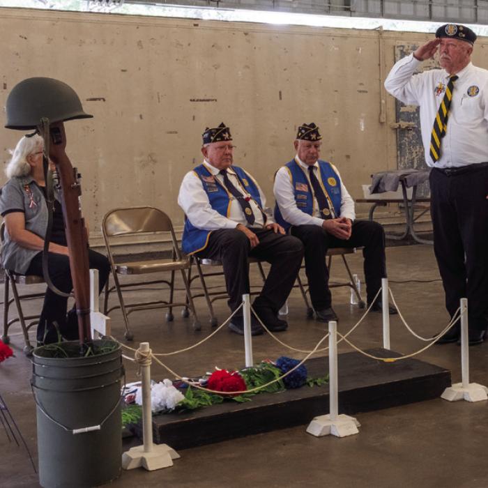Andy Janda of Vietnam Veterans of America Chapter 870 salutes a memorial to fallen service members at the Schulenburg Memorial Day Service on Monday. Photo by Andy Behlen