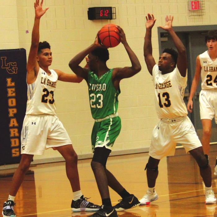La Grange’s Nate Scott, left, and Dana Baker, right, double team this Cuero player in Tuesday’s game. Photo by Jeff Wick