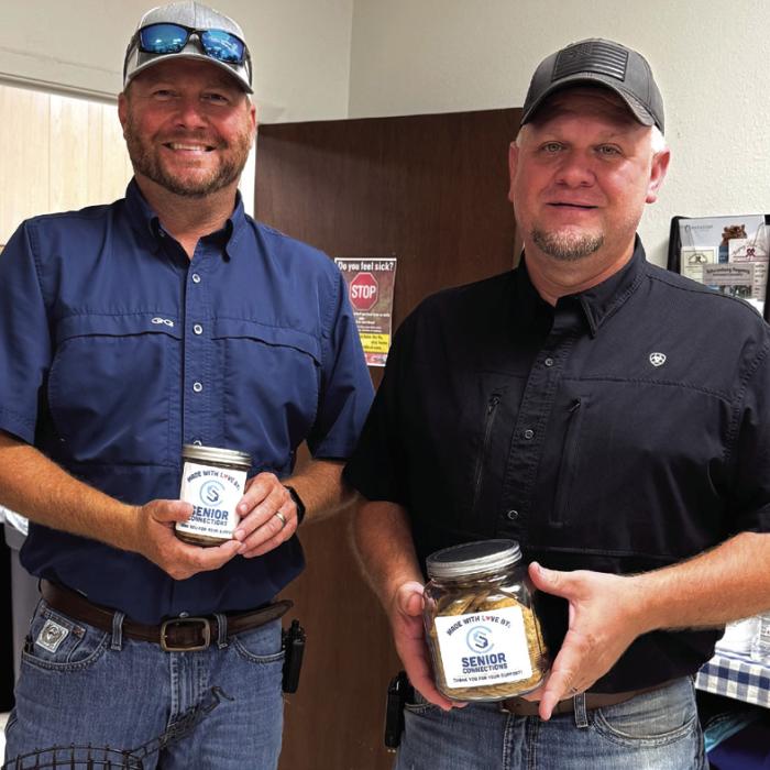 Drew Brossmann, Fayette County Commissioner for Precinct 4 pictured on the left, and Justice of the Peace Paul Zapalac are shown holding cookies baked by our members for Cookie Roundup. These goodies are then gifted to our speakers and bingo callers who make our world go around.