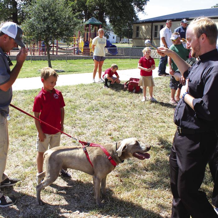 The lawn in front of Sacred Heart School in La Grange was a festive place Tuesday as students and their parents brought cats, dogs, a pony and at least one snake to the annual Blessing of the Pets ceremony in honor of the Feast Day of St. Francis of Assisi, the Patron Saint of Animals. After a short prayer service, Father Brian Phillips, above right, walked around to all the pets and sprinkled them with holy water. Some students even brought their stuffed animals for the event. Photo by Jeff Wick