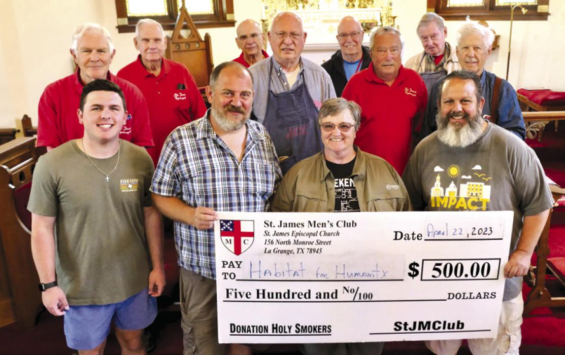 The Holy Smokers recently cooked fo Habitat for Humanity. Pictured front from left are Cole White, Kenny Couch, Jill Stueber, and Khalil Coltrain; back row: Eric Batchelder, Guy Mason, Ernie Balla, Ed Dykes, Bill Bailey, Jim Malik,Paul Crain, and Dan Boyles.