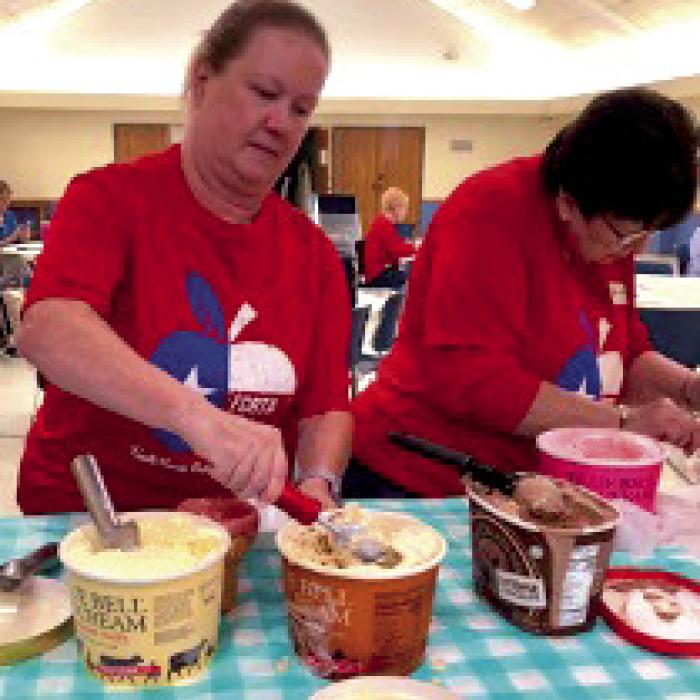 Lisa Slinkard and Jeanne Wetjen prepare sundaes with all the fixings.
