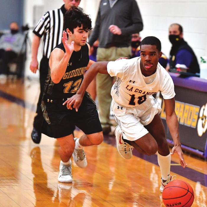 La Grange’s Jordan Scott dribbles the ball in Friday’s game as a Giddings player pursues. Photo by Stephanie Steinhauser