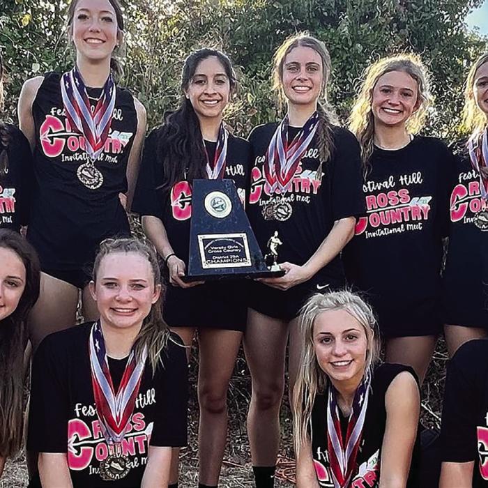 The Round Top-Carmine girls pose with their district title trophy.