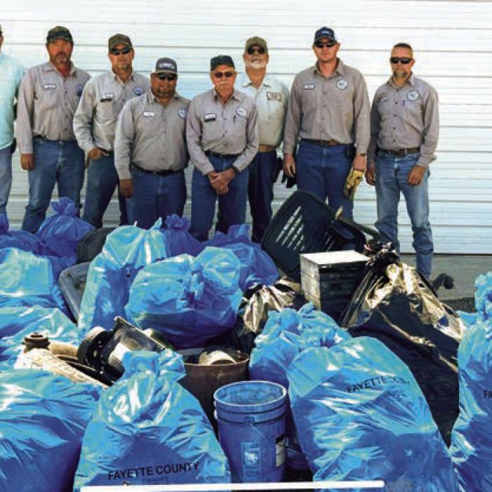 Pct. 4 Commissioner Drew Brossmann and his road and bridge crew picked up dozens of bags of trash along the county roads in Precinct 4 on Tuesday, March 25. Pictured (from left) are Brossmann, David Kunschick, David Osina, Pete Garcia, Jr., Frankie Osina, Mike Fiedler, Josh Morgan and Randy Wick.