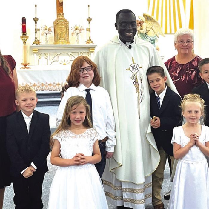 Students from the Hostyn and Plum churches celebrated First Holy Communion May 14 at St. Peter and Paul Catholic Church in Plum. Pictured are (front, from left) Parker Hatfield and Aubrey Gommert, (back) Teacher Brianne Bernsen, Jacoby Zaruba, Frank Machala, Father Felix Twumasi, Penn Wick, Teacher Monica Muras and Waylon Gulash.