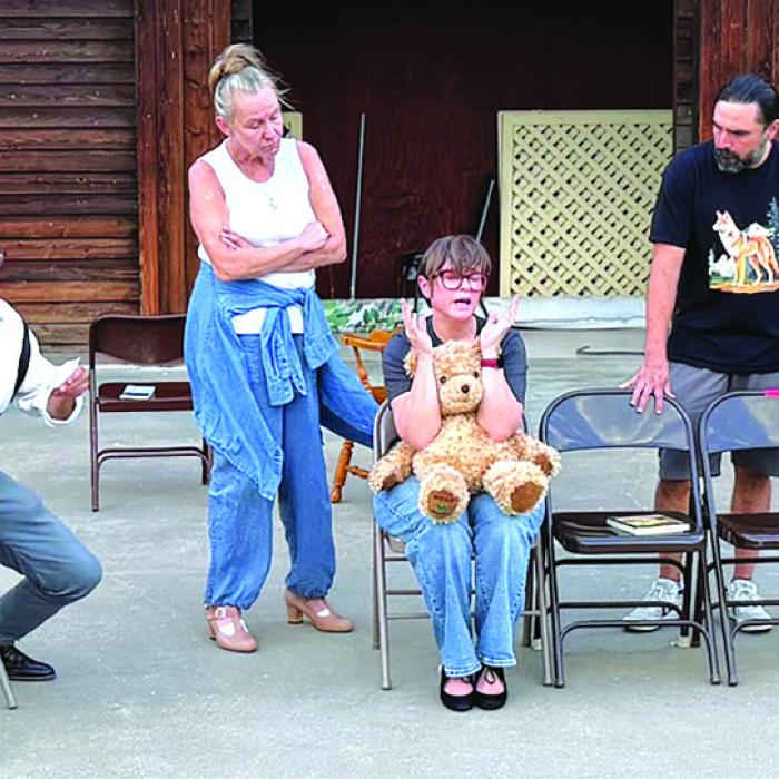 A photo from rehearsal with the cast from left to right: Aaron Rainey, Melissa Weltner, Blythe Cone, and Anthony Lira.