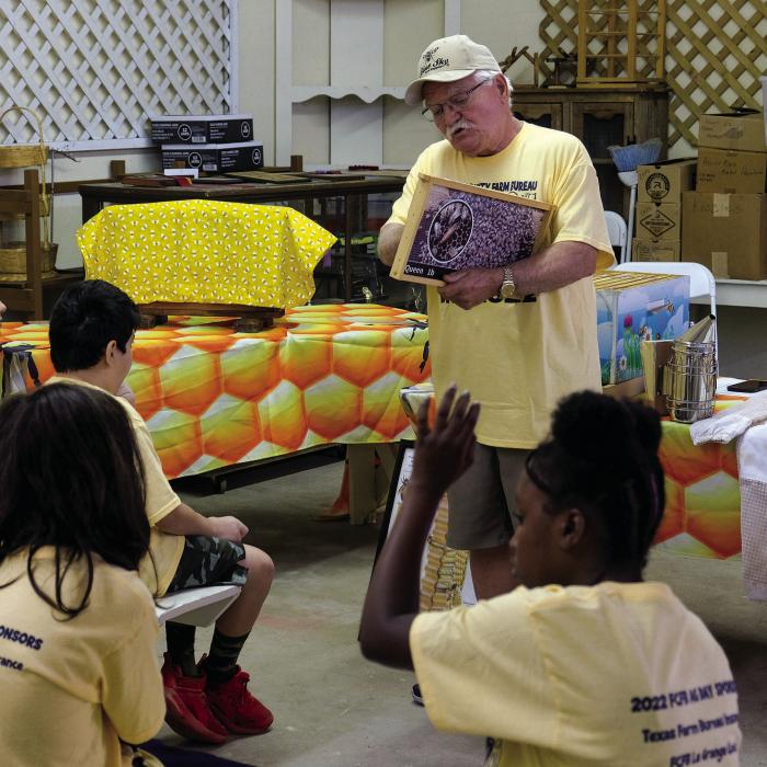 Beekeeper Ron Chess teaches students about the type of frames used in commercial beehives.