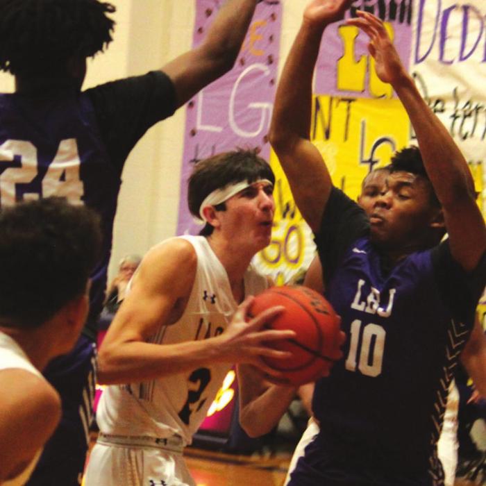La Grange’s Jaxon Cooper tries to get between a pair of Austin LBJ defenders. He scored a team-high 24 points. Photos by Jeff Wick