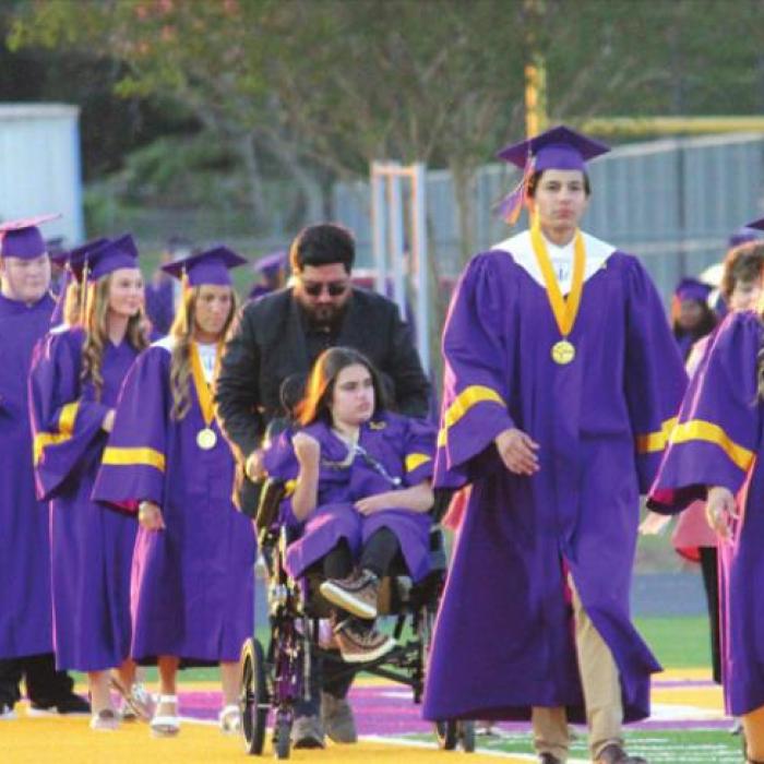 Left: Members of the senior class participated in the annual Grad Walk through the elementary school Thursday in their caps and gowns to be cheered on by the youngsters. Right, top: The graduates gather at midfield to throw their caps into the air at the conclusion of the ceremony. Right, bottom: The graduates walk onto the field at the start of the ceremony. Photos by Jeff Wick