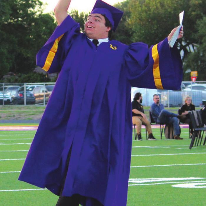 The joy of graduation night shows in the way Daniel Villanueva tries to the get the attention of someone in the crowd as he and the other graduates walked onto the field at the beginning of Thursday’s ceremony in La Grange. Photo by Jeff Wick