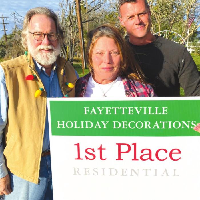 Greater Fayetteville Chamber president Jerry Herring with Christmas Decorations winners Tami and Tony Cartwright.