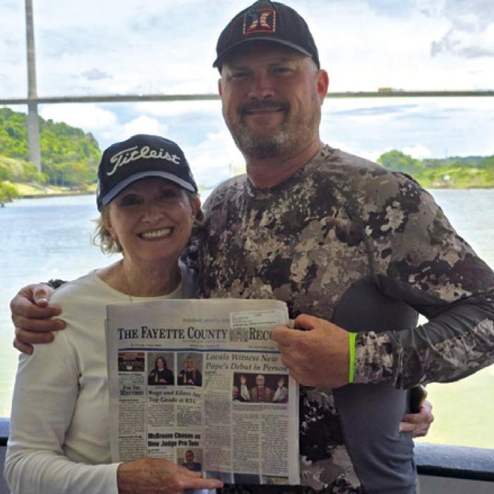 Warda resident Karen Stephenson met her son, Clinton, who lives in Costa Rica, in Panama City, Panama, and took a day cruise through the Panama Canal to Colon aboard the Pacific Queen. The Centennial Bridge is in the background in the photo. She proudly took along the Fayette County Record and is wearing the Titleist cap she won at the neighborhood gathering at the church picnic grounds a couple of years ago.