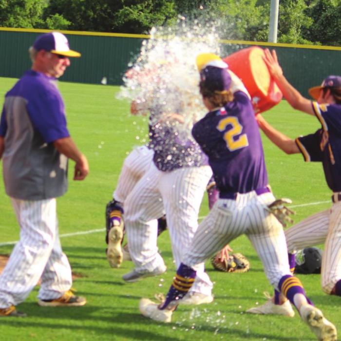 La Grange players dump a cooler of ice water on manager Robert Barber after Saturday’s decisive Game 3 victory. Photos by Jeff Wick