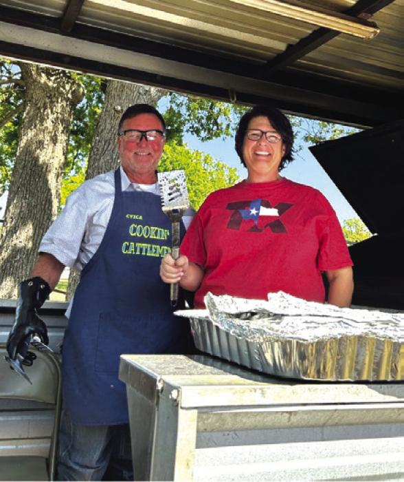 Pictured is Master Chef, Ron Denham, with Tara Sickon, his helper. Not pictured in the photo was Franklin Wagner (Ron’s dad), who prepared the hamburgers for cooking.