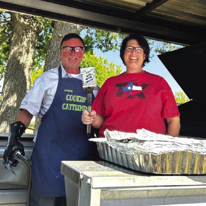 Pictured is Master Chef, Ron Denham, with Tara Sickon, his helper. Not pictured in the photo was Franklin Wagner (Ron’s dad), who prepared the hamburgers for cooking.