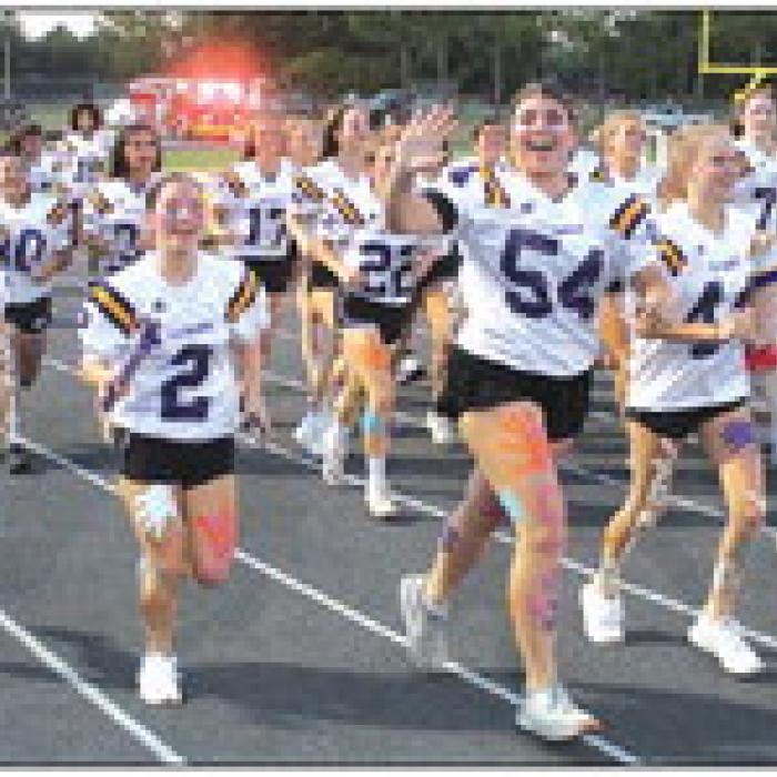 Senior girls athletes run into the stadium to start Wednesday’s pep rally.