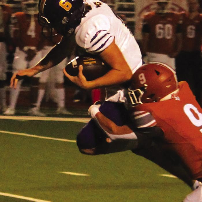 La Grange quarterback Clayton Cooper leaps forward with a Caldwell player hanging into him. Cooper threw for 306 yards and ran for 90 as the Leps beat the Hornet by 21 points. Photo by Jeff Wick
