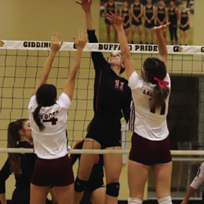 Lady Horn Meredith Magliolo towers above a pair of Thorndale players Thursday.