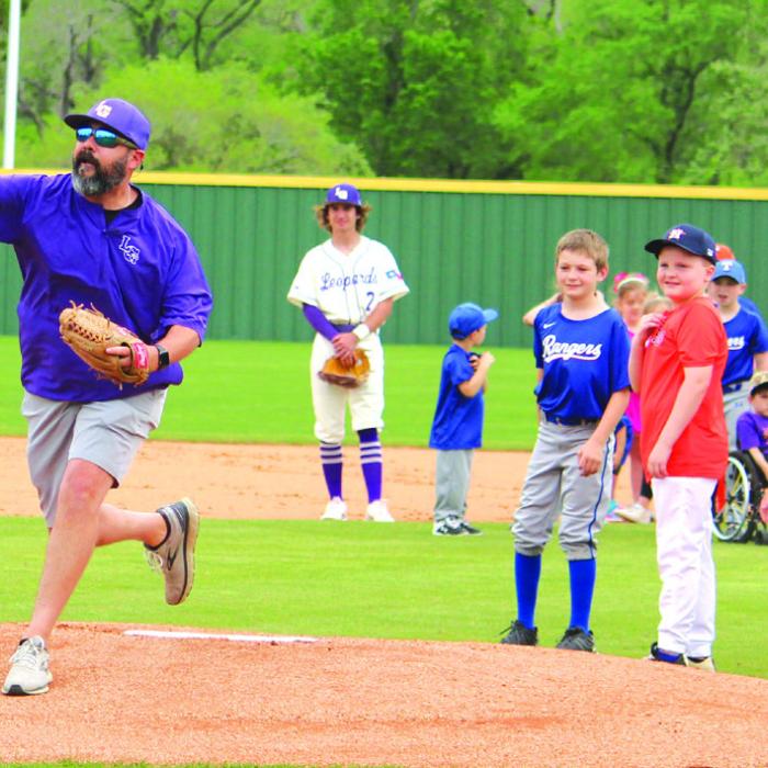 Last Saturday’s Little League Opening Ceremonies was washed out by the weather but there was still some opening week pageantry for the young ballplayers Wednesday as Little League Night was held in conjunction with the Leps varsity baseball game. The youngsters got to go on the field with the players for the National Anthem before La Grange Little League President Jake Kellen, above, threw out the ceremonial first pitch. Photo by Jeff Wick