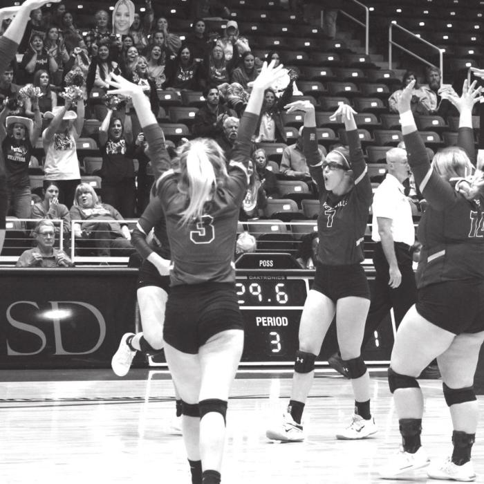 The Lady Lions celebrate a block in the state title match. Photo by Jeff Wick