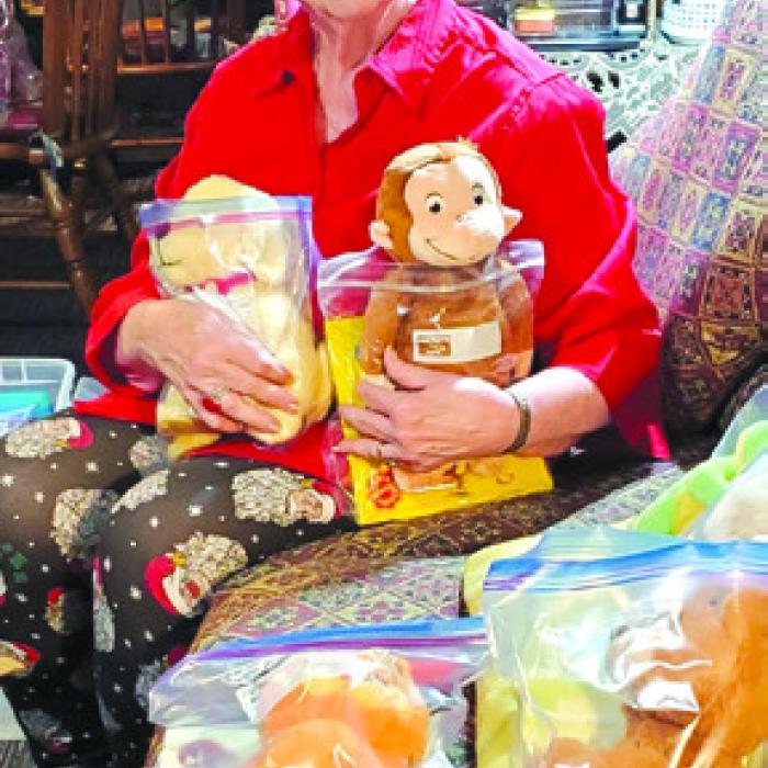 The Project Patriot and Service to Veterans Chairperson, Jo Ann Vasina at her home in East Bernard with donations for USO Houston from members of her Smith-McMillan Chapter, DAR.